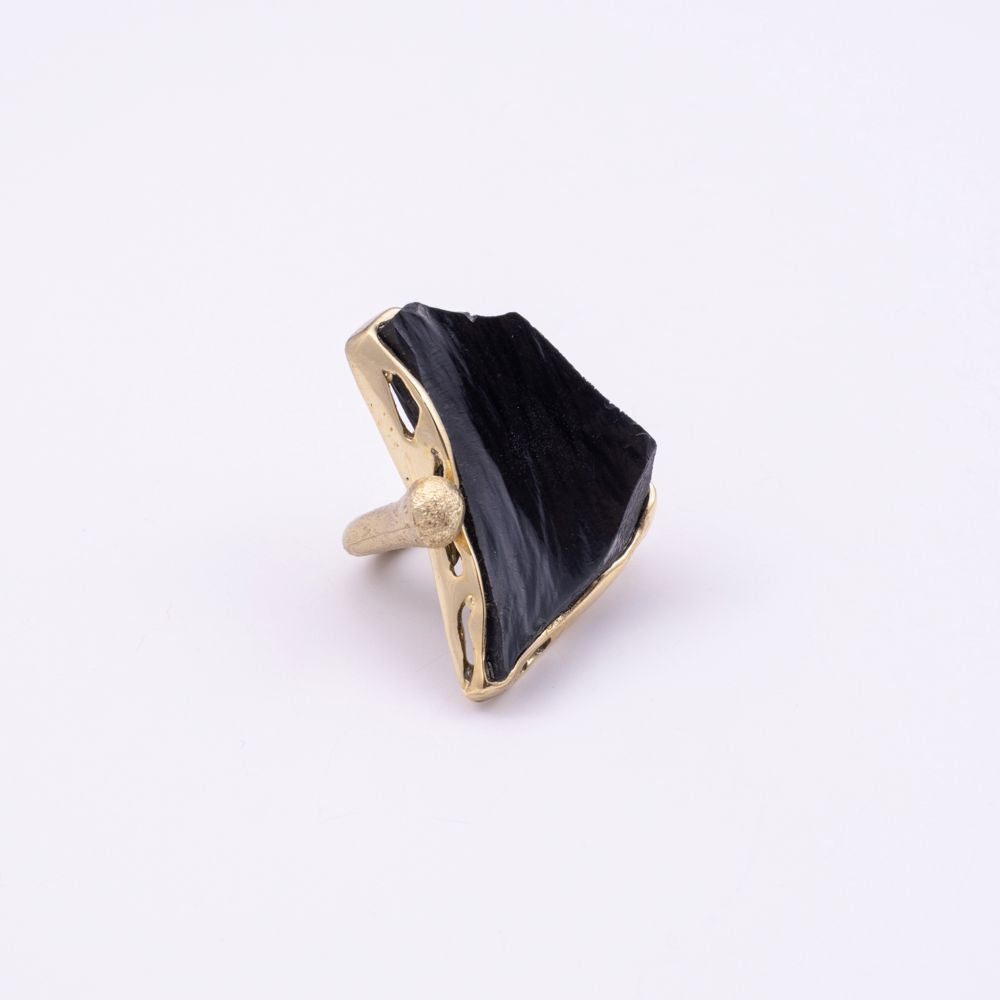 Kate handmade gold-plated cocktail ring with black resin stone and open band with gold ball detail, angled view on white background
