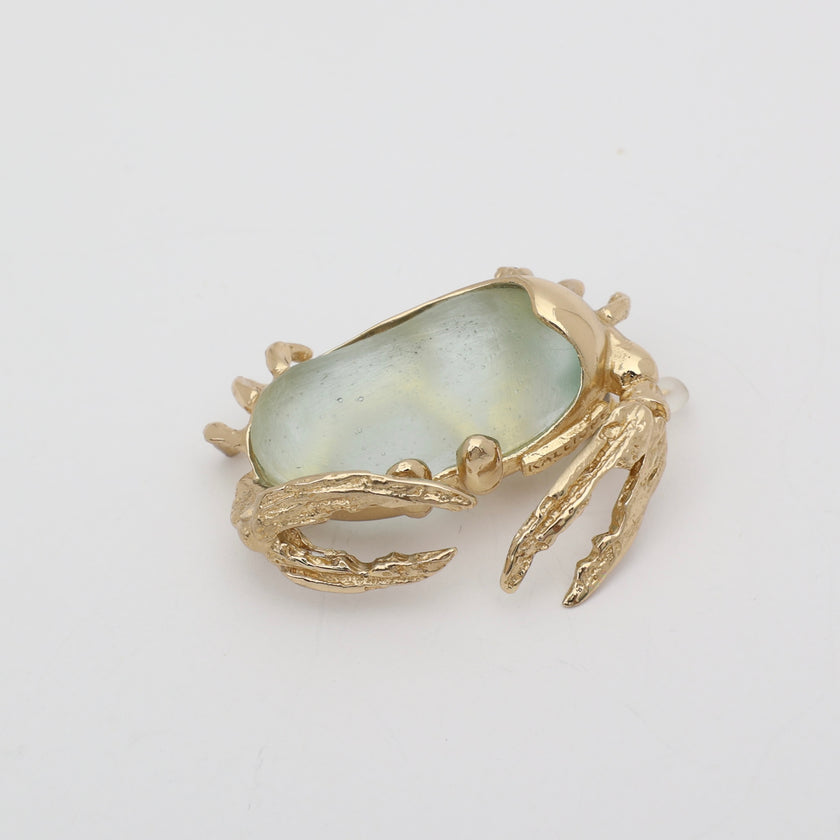 Crabby Pin — handmade brass crab shaped pin with translucent resin stone on white background