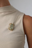 Crabby Pin on model — handmade brass statement crab pin worn on a textured fabric