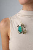 Claw Crabby Pin on model — handmade brass statement crab pin worn on a beige top