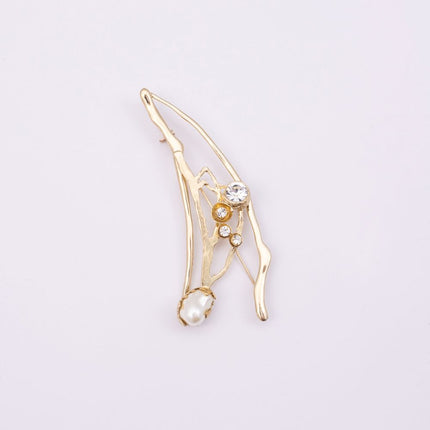Brass branch-shaped pin with pearl and crystal detail, product shot, Nerea