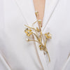 Brass flower pin with pearl buds and colored crystals worn on lapel
