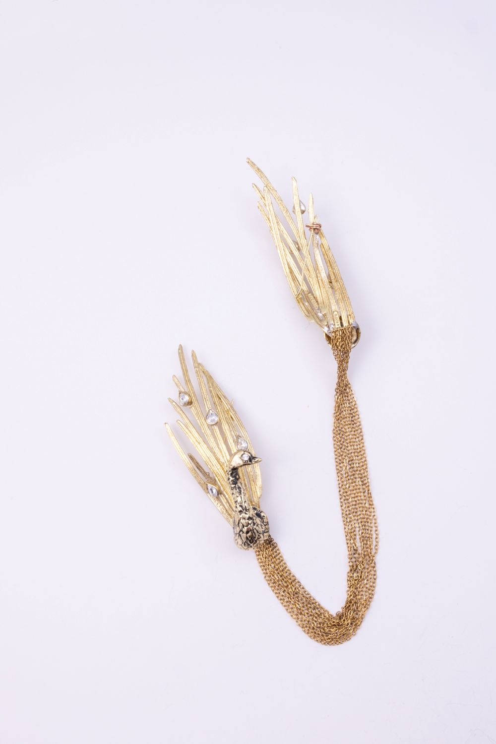Peacock handmade gold-plated brass brooch with teardrop crystals and multi-strand chain, back pin detail on white background