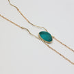 Elemental Pebble Necklace — handmade brass long necklace with trailing bar tipped chains on white background