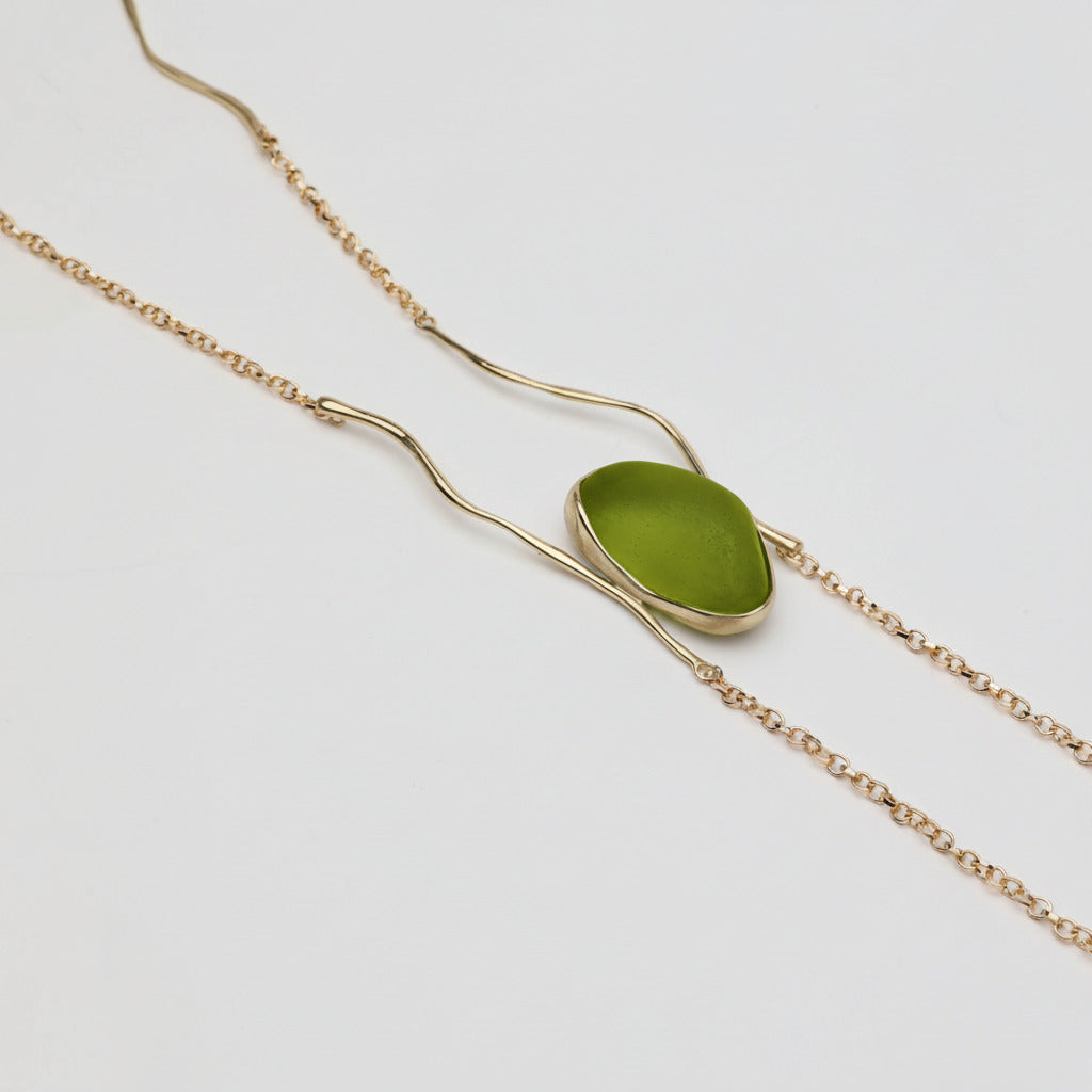 Elemental Pebble Necklace — handmade brass necklace with resin stone centerpiece, chain detail on white background