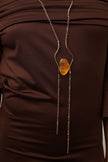 Elemental Pebble Necklace flat lay — handmade brass long necklace with resin stone pendant, full view