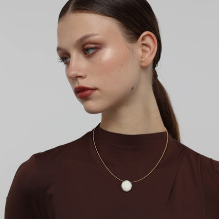 Kiss Necklace — handmade brass wire necklace with round resin stone pendant on model