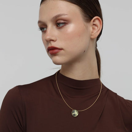 Kiss Necklace side view — handmade brass choker necklace with organic pebble shaped resin stone