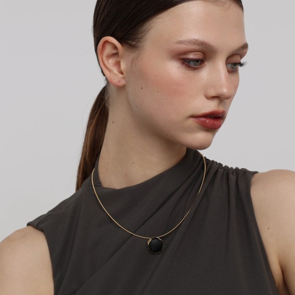 Kiss Necklace on model — handmade brass choker necklace worn resting on collarbone