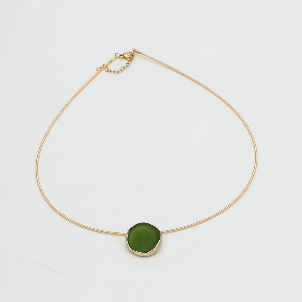 Kiss Necklace — handmade brass wire necklace with organic pebble pendant, product shot on white background