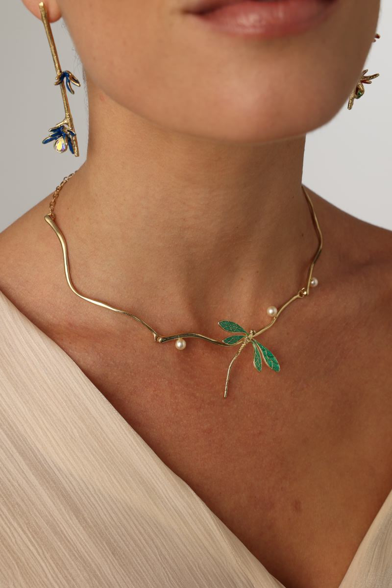 Buzz Necklace — handmade brass dragonfly necklace with enamel wings and freshwater pearls, worn on model