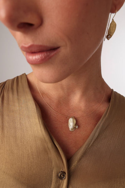 Limpet Necklace — handmade brass jewelry crystal pendant necklace with a sea shell charm on model