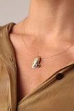 Limpet Necklace close-up — artisan brass jewelry featuring a textured limpet shell pendant with a sparkling crystal