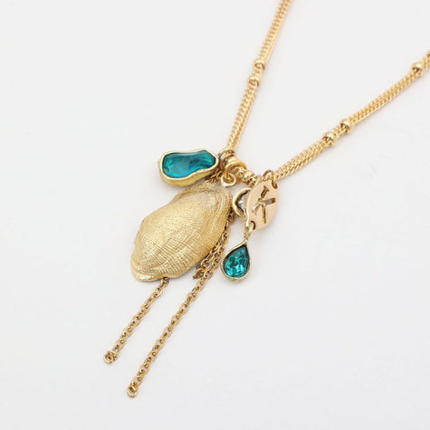 Charmy Limpet Necklace flat lay — bohemian multi-strand charm necklace, handmade jewelry made in Greece
