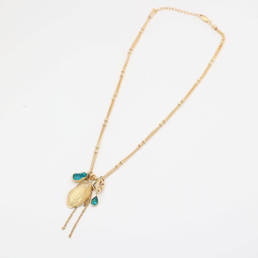 Gold necklace with a shell pendant on a white background