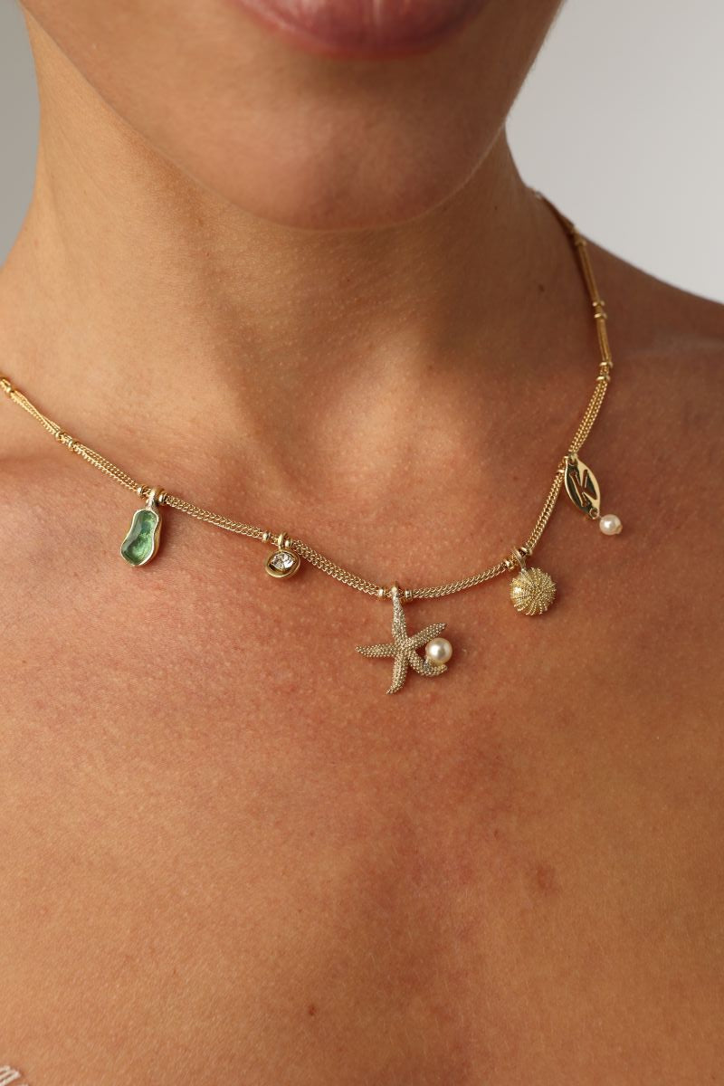 Charmy Tide Necklace — handmade brass jewelry sea charm necklace on model