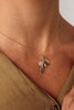 Alea Necklace — handmade brass olive branch pendant necklace with crystal and sculpted leaf motifs on white background