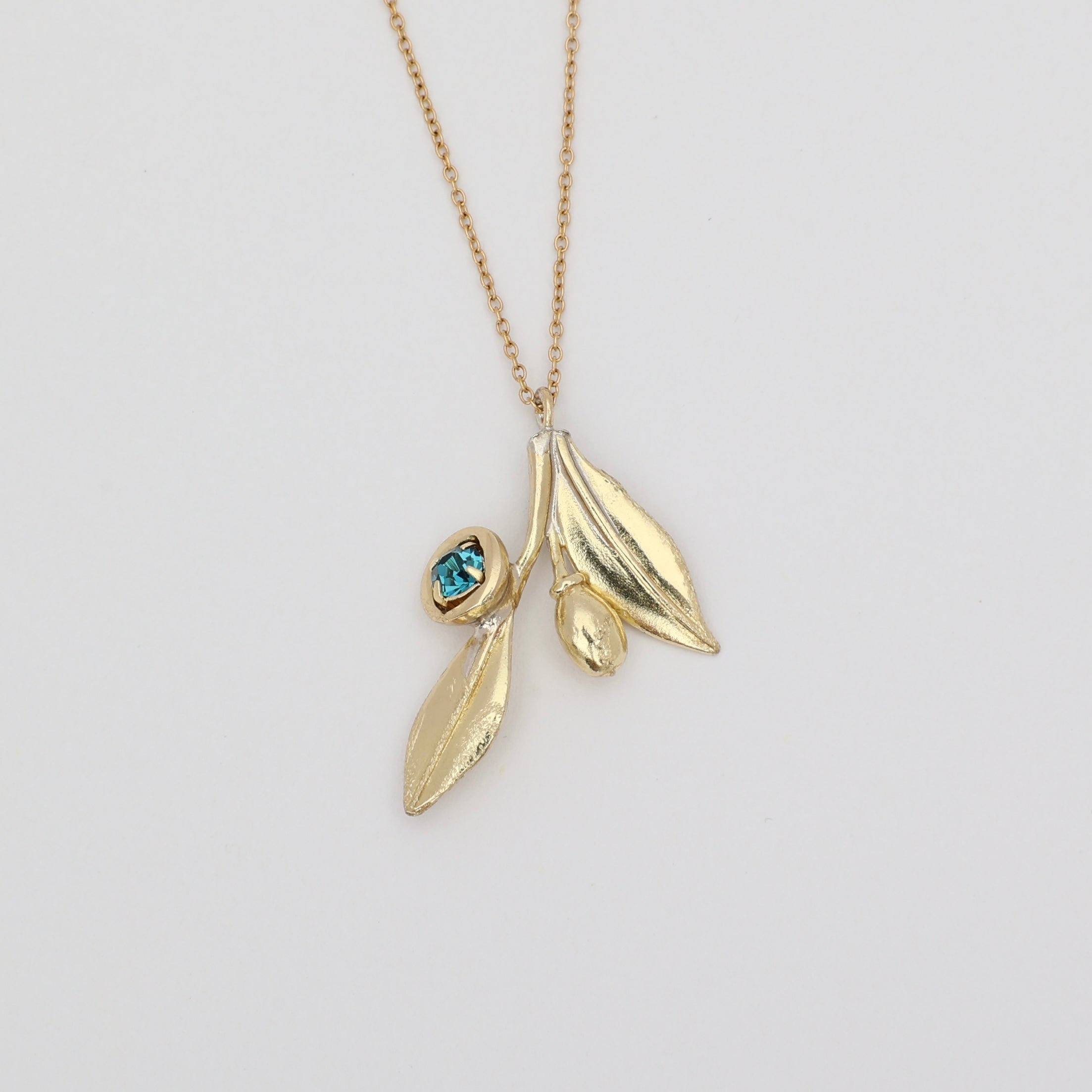 Alea Necklace product shot — handmade brass nature-inspired pendant necklace from the Olive Tales collection