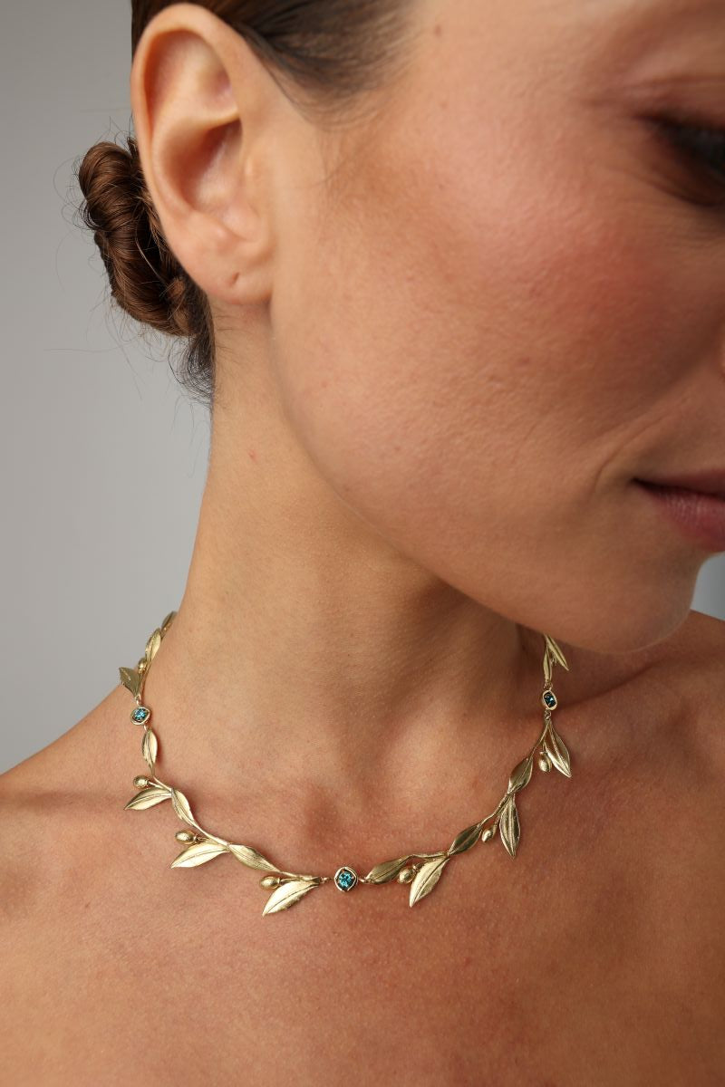 handmade brass botanical necklace with bezel-set crystals worn on neck