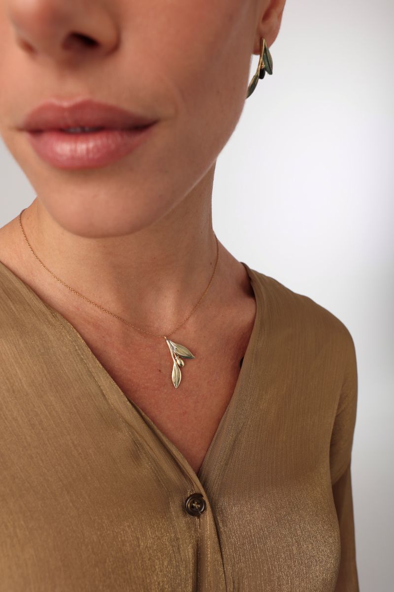 Lio Necklace close-up — handmade brass botanical pendant necklace with olive leaves and fruit, artisan jewelry made in Greece
