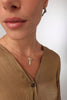 Lio Necklace close-up — handmade brass botanical pendant necklace with olive leaves and fruit, artisan jewelry made in Greece