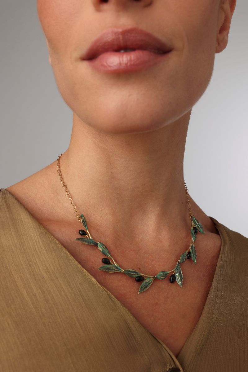 Demi Selia Necklace close-up on model — handmade brass botanical enamel necklace from the Olive Tales collection, artisan jewelry made in Greece