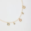 Lunelle Necklace close-up — handmade brass crystal and gemstone charms on pearl necklace