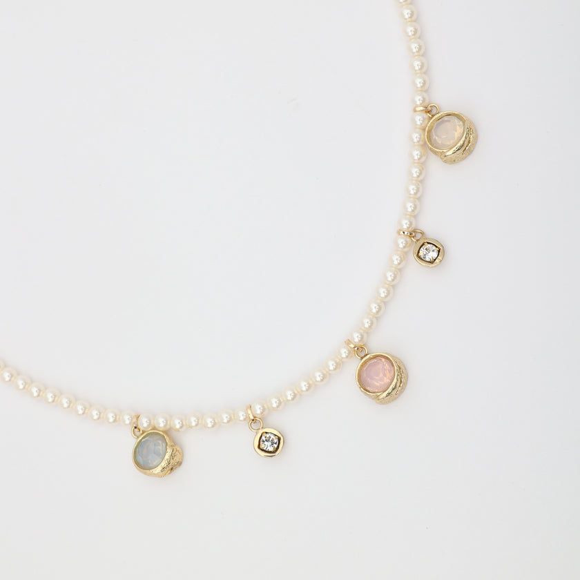 Lunelle Necklace close-up — handmade brass crystal and gemstone charms on pearl necklace
