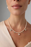 Lunelle Necklace — handmade pearl necklace with brass crystal charm pendants worn on model