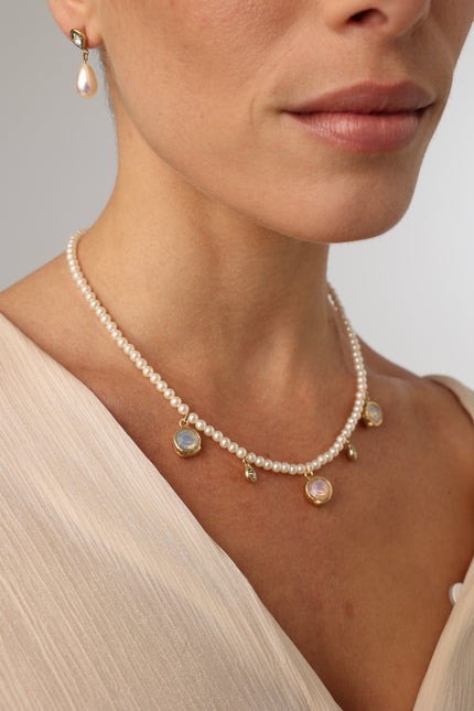 Lunelle Necklace on model — freshwater pearl necklace with gemstone and crystal charms in brass