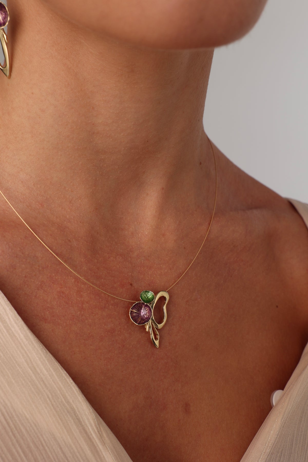 Nolia Necklace on model — sculptural brass enamel statement necklace in purple and green