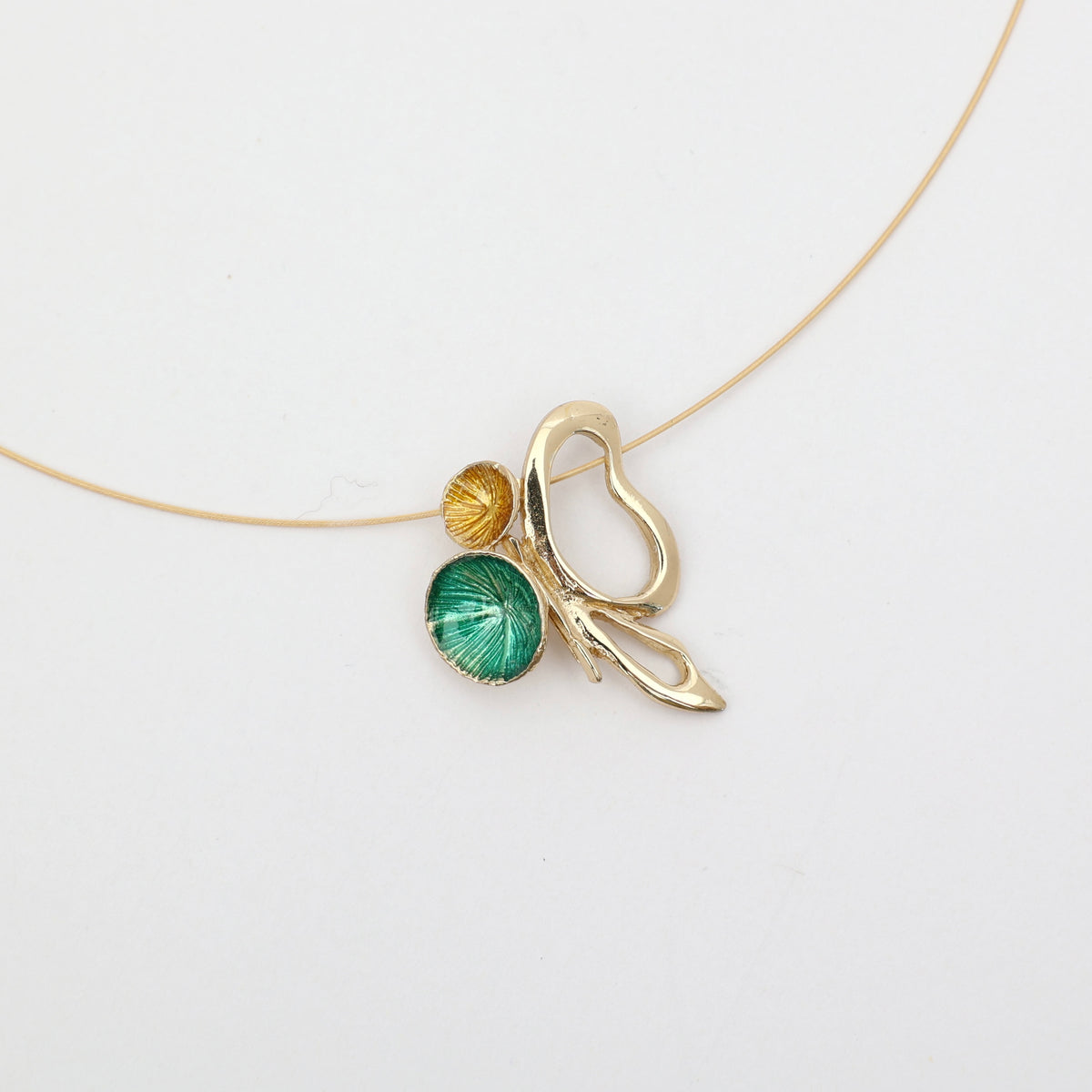 Nolia Necklace — handmade brass pendant with green and yellow enamel discs on wire chain