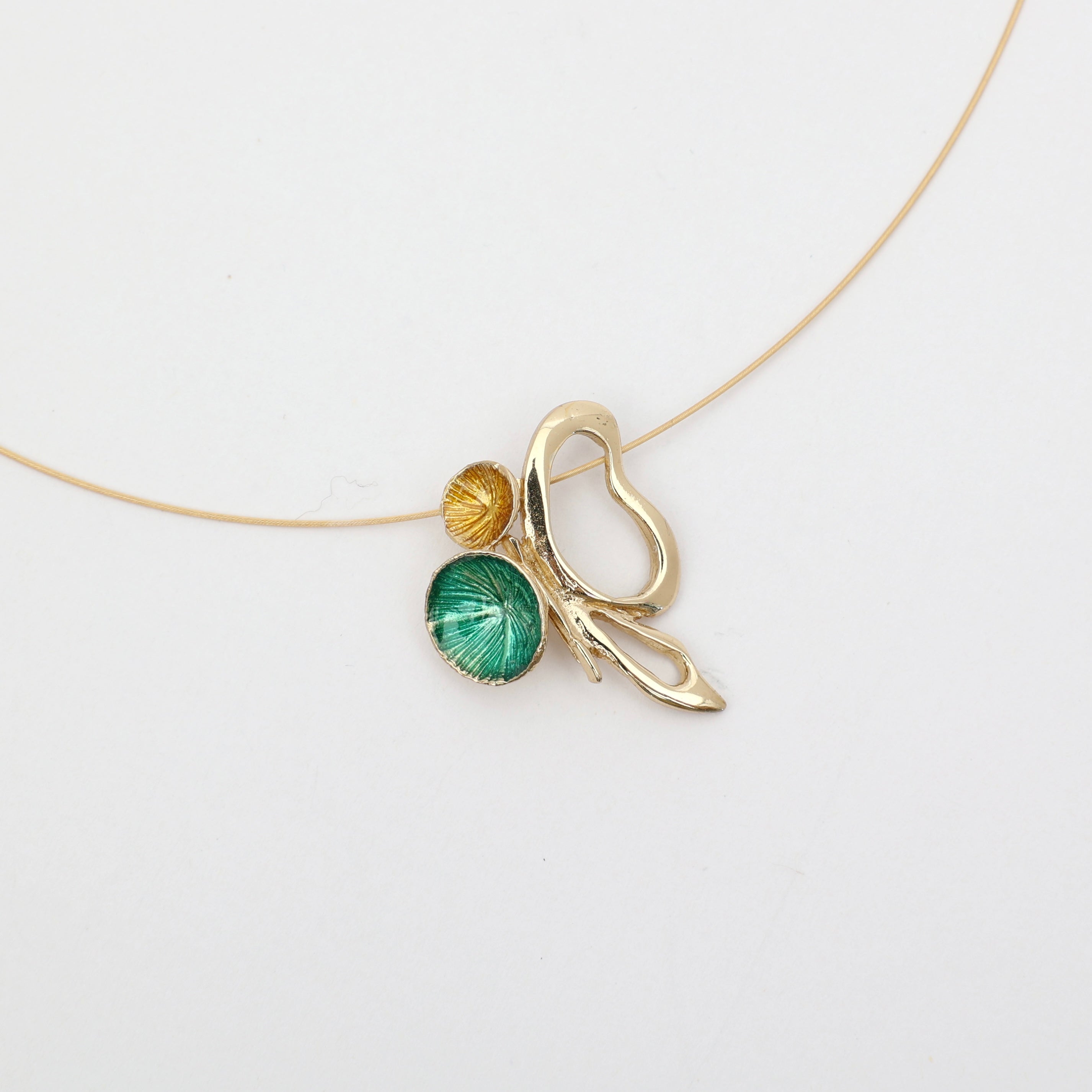 Nolia Necklace — handmade brass pendant with green and yellow enamel discs on wire chain