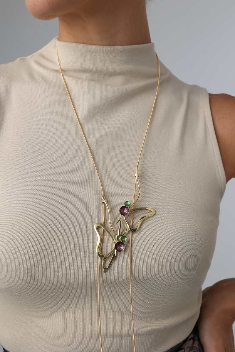 Vela Necklace — long handmade brass enamel statement necklace worn on model, purple and green