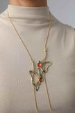 Vela Necklace on model — oversized sculptural brass pendant long necklace, orange and green enamel