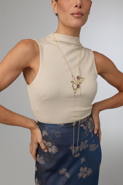 Vela Necklace — artisan brass sculptural long necklace with enamel accents, worn on model