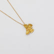 Gold butterfly pendant necklace on a light gray background