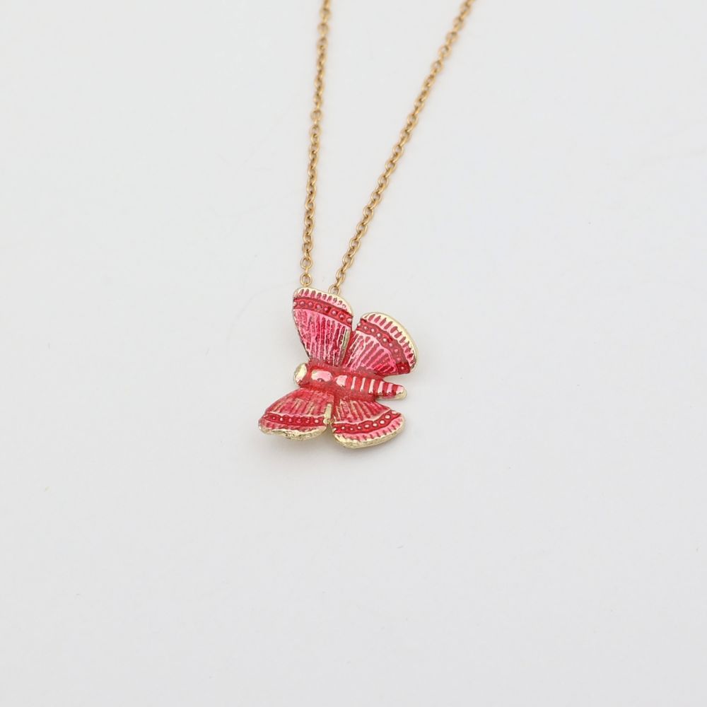 Necklace with a pink bow pendant on a light gray background