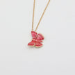 Necklace with a pink bow pendant on a light gray background