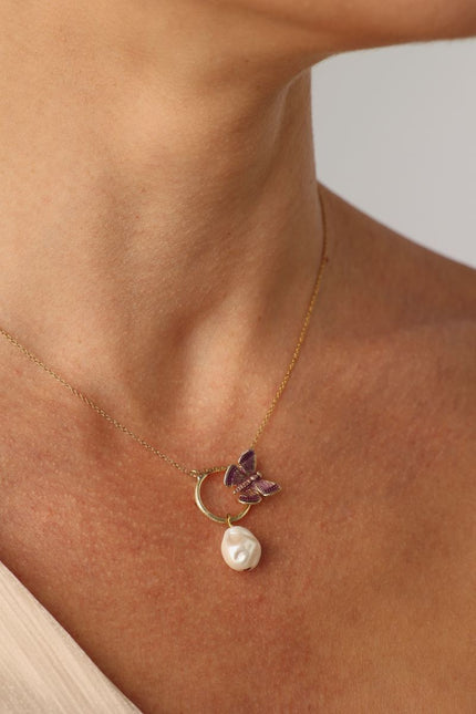 Elysian Necklace — handmade brass butterfly enamel necklace with baroque pearl pendant, worn on model