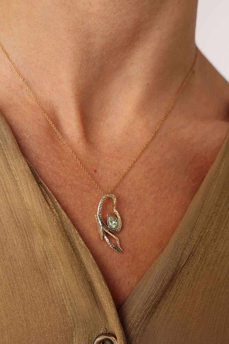 Flutter Necklace — sculptural brass gemstone pendant necklace worn on model, green stone