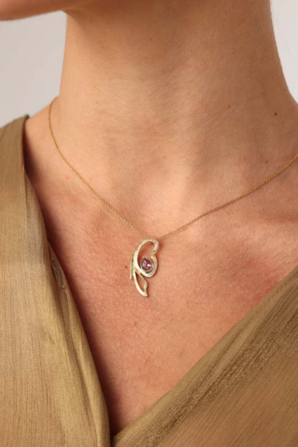 Flutter Necklace on model — artisan brass pendant necklace with pink teardrop gemstone