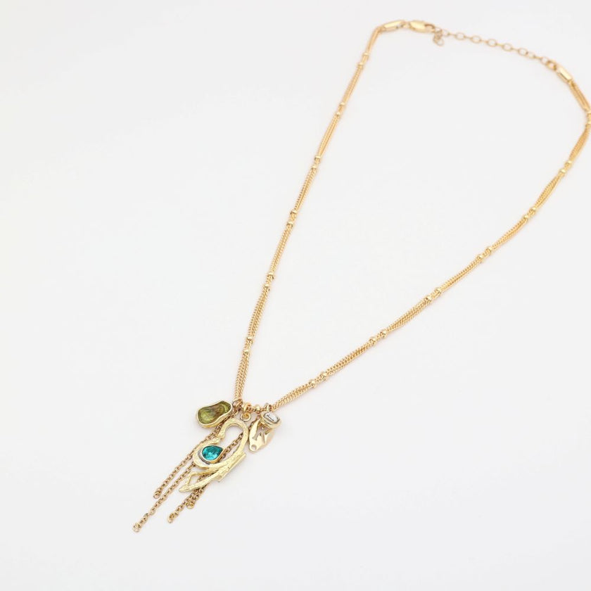 Gold necklace with a pendant on a white background