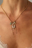 Liora Necklace on model — artisan brass charm necklace with layered gemstone pendants and dangling chains