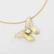 Nymia Necklace on model — handmade brass butterfly gemstone statement necklace on rigid wire chain