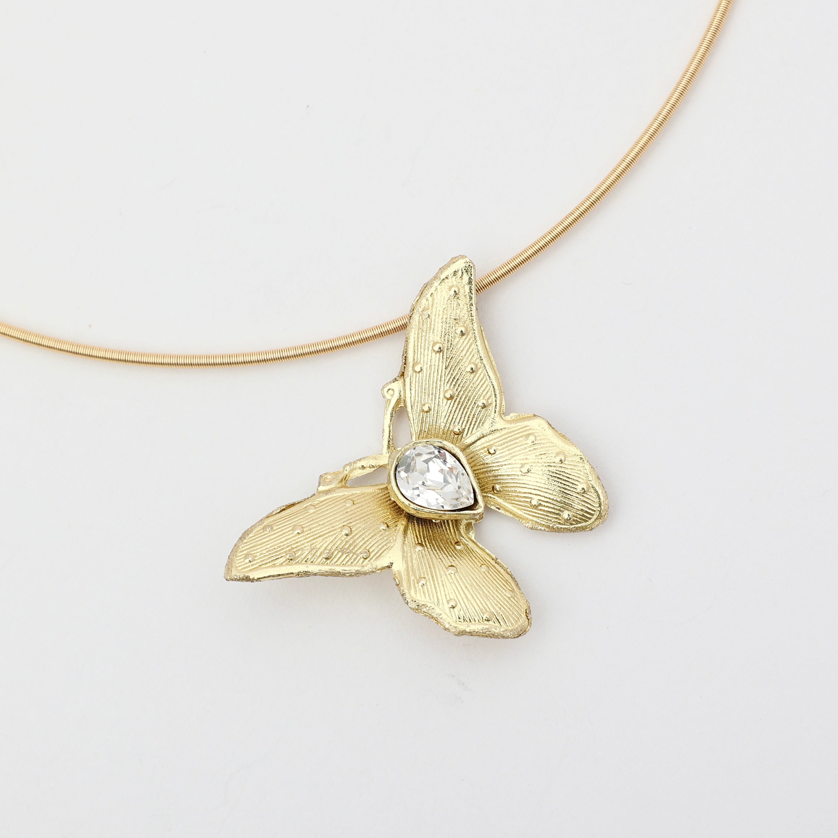Nymia Necklace on model — handmade brass butterfly gemstone statement necklace on rigid wire chain