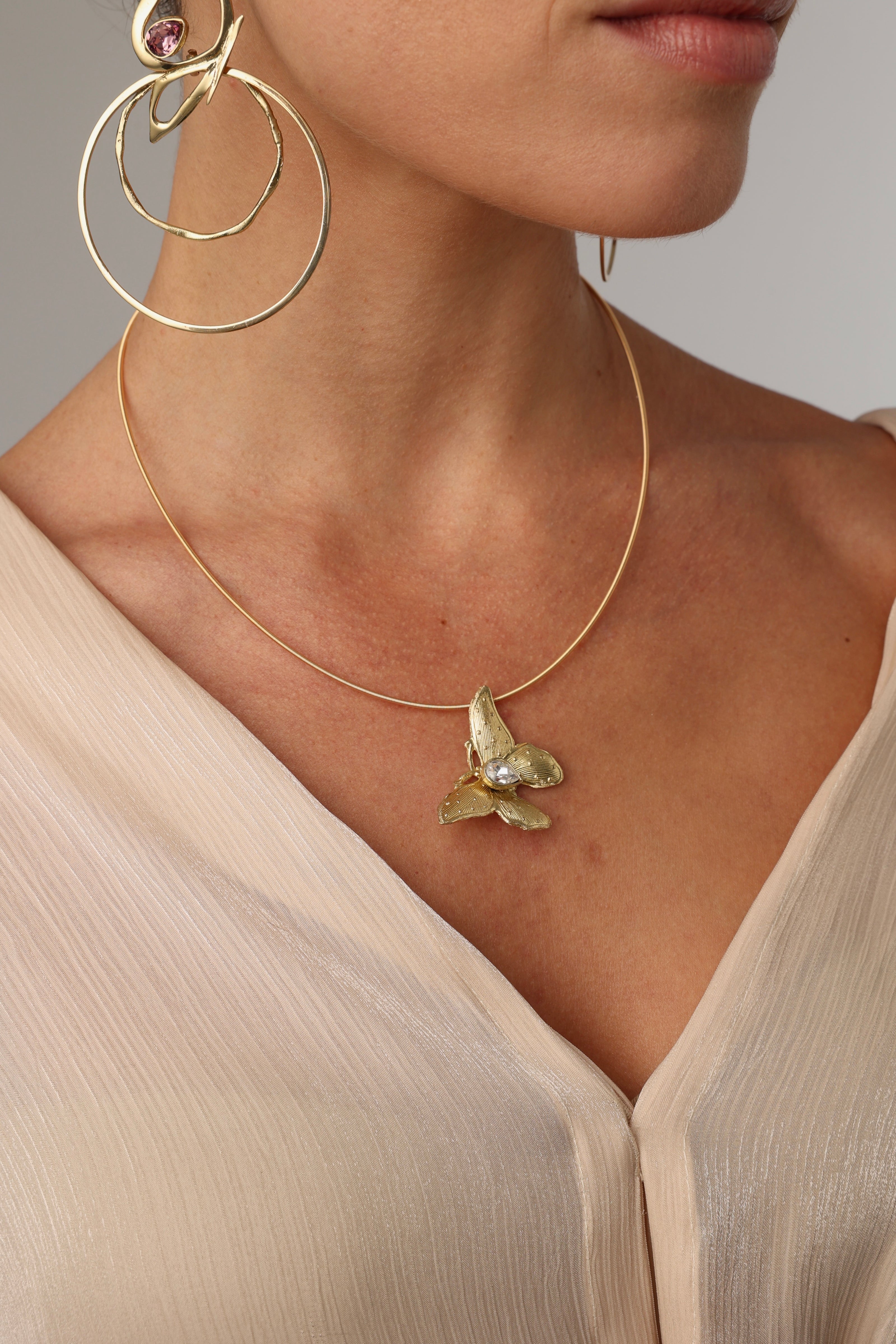 Nymia Necklace — sculptural brass butterfly necklace with crystal teardrop gemstone on wire chain