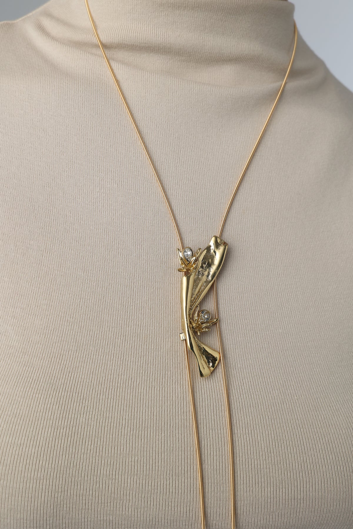  Navily Necklace, handmade gold brass lariat with red enamel and green crystal worn by model, Greek artisan jewelry.