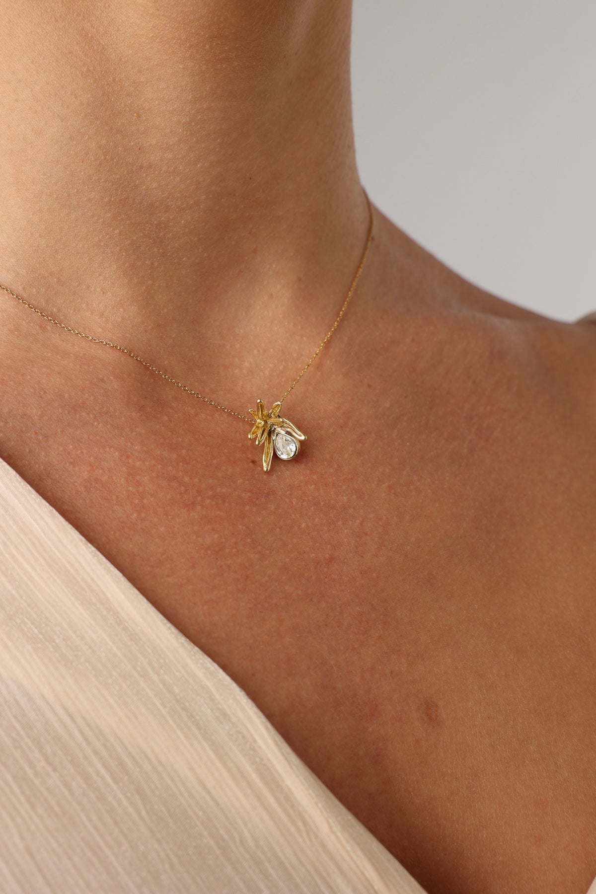 Small handmade brass coral pendant with a teardrop crystal and colorful enamel, handcrafted in Greece