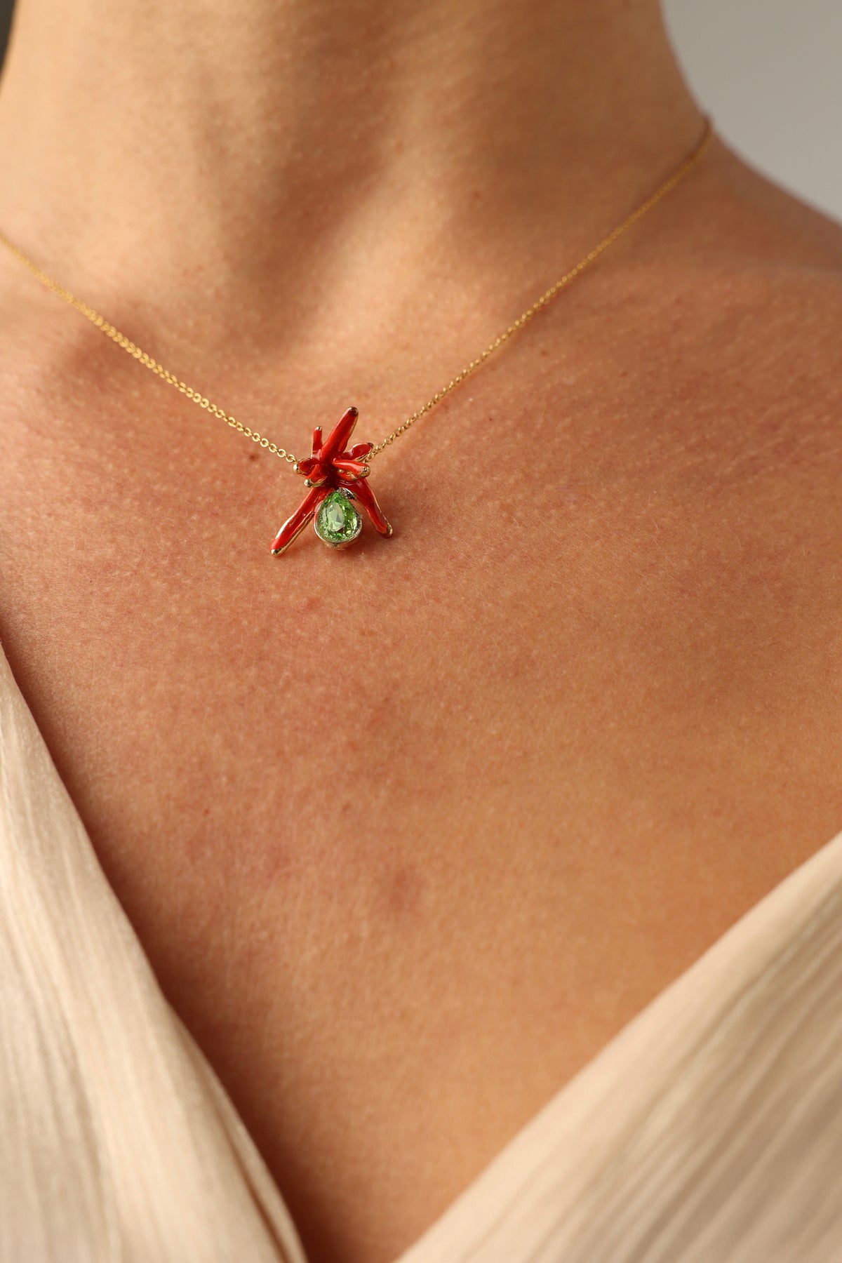 Small handmade brass coral pendant with a teardrop crystal and colorful enamel, handcrafted in Greece